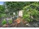 Backyard garden with small shed, metal garden bed, and established vines at 6221 Thermal Rd, Charlotte, NC 28211