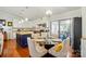 Modern kitchen with granite countertops, white cabinets, and a dining area at 6221 Thermal Rd, Charlotte, NC 28211