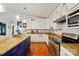 Well-lit kitchen featuring granite countertops, stainless steel appliances, and wooden floors at 6221 Thermal Rd, Charlotte, NC 28211