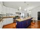 Bright kitchen with white cabinets, stainless steel appliances, and blue island with dining at 6221 Thermal Rd, Charlotte, NC 28211
