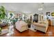 Bright living room with hardwood floors, cream sofas, and large windows for natural light at 6221 Thermal Rd, Charlotte, NC 28211