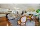 Open-concept living room with neutral furniture, hardwood floors, and stylish lighting at 6221 Thermal Rd, Charlotte, NC 28211