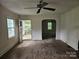 Spacious living room with access to the front porch and a dining area at 6407 Market St, Charlotte, NC 28215