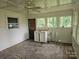 Sunroom featuring sink, storage, multiple windows, and tile flooring at 6407 Market St, Charlotte, NC 28215