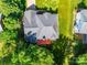 Bird's-eye view of a home with a gray roof and a cozy red deck, surrounded by dense green foliage at 7006 Olde Sycamore Dr, Mint Hill, NC 28227