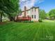 Expansive backyard featuring a well-manicured lawn and a charming deck perfect for outdoor enjoyment at 7006 Olde Sycamore Dr, Mint Hill, NC 28227