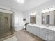 Elegant bathroom featuring a freestanding tub, glass shower, and dual vanities at 7006 Olde Sycamore Dr, Mint Hill, NC 28227