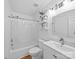 Well-lit bathroom with a shower, a plant, a single sink, and modern fixtures and finishes at 7006 Olde Sycamore Dr, Mint Hill, NC 28227
