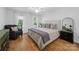 Bright bedroom featuring hardwood floors, natural light, and stylish furnishings, creating a cozy and inviting space at 7006 Olde Sycamore Dr, Mint Hill, NC 28227