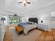 Spacious bedroom with a trey ceiling, a large window, and hardwood floors at 7006 Olde Sycamore Dr, Mint Hill, NC 28227