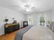 Comfortable bedroom featuring neutral walls, natural light, and hardwood floors, creating a relaxing retreat at 7006 Olde Sycamore Dr, Mint Hill, NC 28227