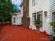 Inviting red-stained deck with a brick chimney, offering an ideal space for relaxation and outdoor gatherings at 7006 Olde Sycamore Dr, Mint Hill, NC 28227
