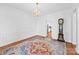 Elegant dining area featuring a chandelier, hardwood floors, and vintage grandfather clock at 7006 Olde Sycamore Dr, Mint Hill, NC 28227