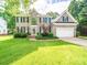 Stately brick home featuring manicured lawn and a two-car garage at 7006 Olde Sycamore Dr, Mint Hill, NC 28227