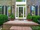 Charming front entrance with decorative wreath, potted greenery, and elegant sidelights at 7006 Olde Sycamore Dr, Mint Hill, NC 28227