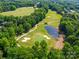 Picturesque view of a meticulously kept golf course, complete with a scenic pond and mature trees at 7006 Olde Sycamore Dr, Mint Hill, NC 28227