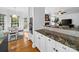 Open kitchen/living room offers granite counters, white cabinets, and a breakfast nook at 7006 Olde Sycamore Dr, Mint Hill, NC 28227