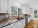 Bright kitchen boasts granite countertops, a copper sink, and stainless steel appliances at 7006 Olde Sycamore Dr, Mint Hill, NC 28227