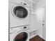 Convenient laundry room with stacked washer and dryer and storage at 7006 Olde Sycamore Dr, Mint Hill, NC 28227