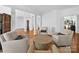 Open-concept living space with hardwood floors, columns, and comfortable seating at 7006 Olde Sycamore Dr, Mint Hill, NC 28227