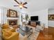 Cozy living room with fireplace, plush seating, and natural light at 7006 Olde Sycamore Dr, Mint Hill, NC 28227