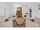 Bright living room with neutral armchairs and a unique round coffee table at 7006 Olde Sycamore Dr, Mint Hill, NC 28227
