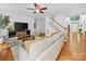 Bright living room with hardwood floors, staircase, and comfortable seating at 7006 Olde Sycamore Dr, Mint Hill, NC 28227