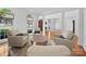 Spacious living room featuring hardwood floors, arched windows, and designer furnishings at 7006 Olde Sycamore Dr, Mint Hill, NC 28227