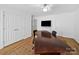 Bright office with hardwood floors, white walls, natural light, and a large desk for working at 7006 Olde Sycamore Dr, Mint Hill, NC 28227