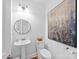 Modern powder room featuring pedestal sink, toilet and decorative art at 7006 Olde Sycamore Dr, Mint Hill, NC 28227
