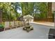 Spacious backyard featuring a picnic table, chairs, and a storage shed at 7416 Cross Tie Ct, Mint Hill, NC 28227