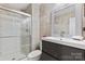 Modern bathroom with glass shower, sleek vanity, and neutral-toned tile at 7416 Cross Tie Ct, Mint Hill, NC 28227
