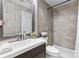 Stylish bathroom featuring a modern sink and vanity, a shower with tile surround, and updated fixtures at 7416 Cross Tie Ct, Mint Hill, NC 28227