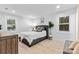 Bright bedroom features a queen-sized bed, a large window, and light wood floors at 7416 Cross Tie Ct, Mint Hill, NC 28227
