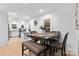 Cozy dining room with modern table setting with new table and chairs, adjacent to the kitchen at 7416 Cross Tie Ct, Mint Hill, NC 28227