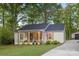 Charming home with a covered front porch, landscaped garden, and a well-maintained green lawn at 7416 Cross Tie Ct, Mint Hill, NC 28227