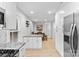 Modern kitchen with stainless steel appliances, granite countertops, and island overlooks the dining area at 7416 Cross Tie Ct, Mint Hill, NC 28227