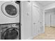 Convenient laundry area with stacked washer and dryer units and storage space at 7416 Cross Tie Ct, Mint Hill, NC 28227