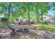 Private backyard with mature trees, a deck, a fence, and a fire pit at 7600 Ridgefield Dr, Charlotte, NC 28269