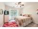 Bright bedroom with a large window and ceiling fan with unique decorations at 7600 Ridgefield Dr, Charlotte, NC 28269