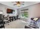 Study featuring a desk with two chairs, shelves, TV and a sofa at 7600 Ridgefield Dr, Charlotte, NC 28269