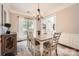 Bright dining room with a classic chandelier, large window, and seating for six at 7600 Ridgefield Dr, Charlotte, NC 28269