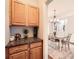 Charming dining room featuring hardwood floors, an elegant chandelier, and a doorway view of a coffee station at 7600 Ridgefield Dr, Charlotte, NC 28269