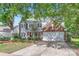 Charming two-story brick home with a well-manicured lawn and attached two car garage at 7600 Ridgefield Dr, Charlotte, NC 28269