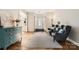 Inviting living room featuring hardwood floors, large windows, and comfortable seating at 7600 Ridgefield Dr, Charlotte, NC 28269