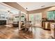 Open-concept living room featuring hardwood floors, natural light, and a cozy dining area at 7600 Ridgefield Dr, Charlotte, NC 28269