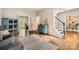 Elegant living room showcasing hardwood floors, a staircase, and stylish furniture at 7600 Ridgefield Dr, Charlotte, NC 28269
