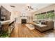 Spacious living room with hardwood floors, stone fireplace, and plenty of natural light at 7600 Ridgefield Dr, Charlotte, NC 28269