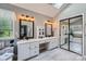 Bright bathroom featuring double sinks, vanity, mirrors and a walk-in closet at 7600 Ridgefield Dr, Charlotte, NC 28269