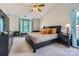 Comfortable main bedroom with a bay window, ceiling fan and a black dresser at 7600 Ridgefield Dr, Charlotte, NC 28269